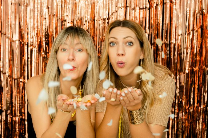 Charming women with confetti on party