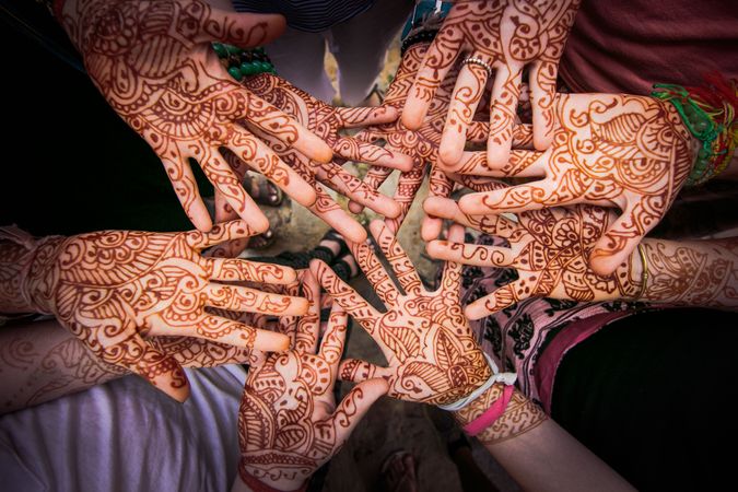 Group of hands showing henna tattoo