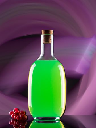 Bottle with drink near berries