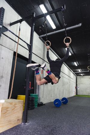 Man hanging on gymnastic rings