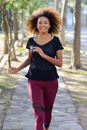Smiling woman jogging outside