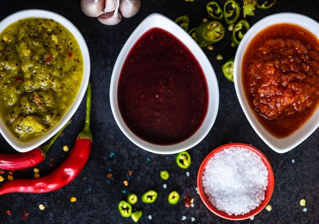 Top view of three spicy colorful Georgian condiments