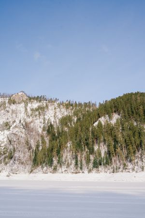 Winter landscape with snowy rocks and blue sky