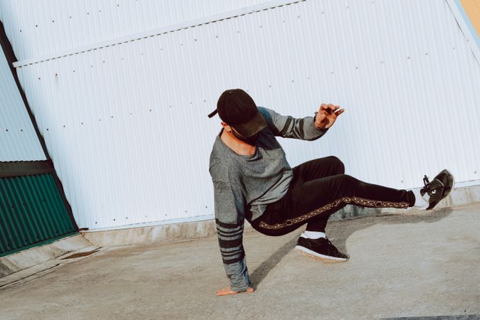 Man performing handstand near wall