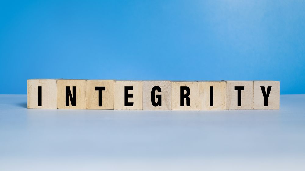 integrity word text on wooden blocks on blue background