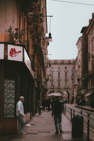 People walking on sidewalk near buildings