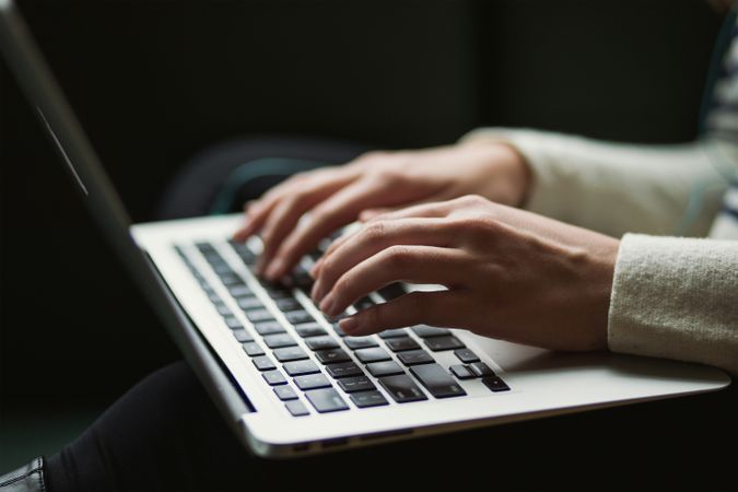 Female Hands Typing on Laptop in Soft Focus