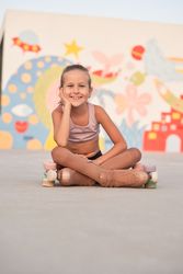 Child in tights and roller skates in skate park