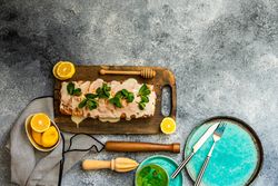 Top view of fresh lemon cake on grey kitchen counter with copy space