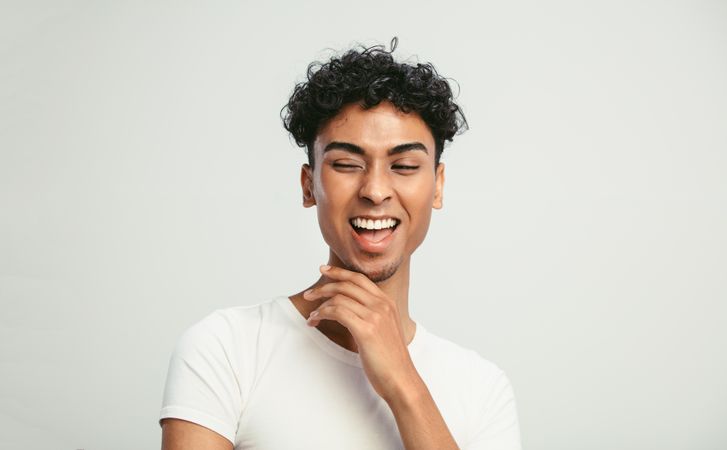 Portrait of a man looking happy on light background