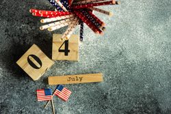 Top view of USA flags for Independence Day on grey counter