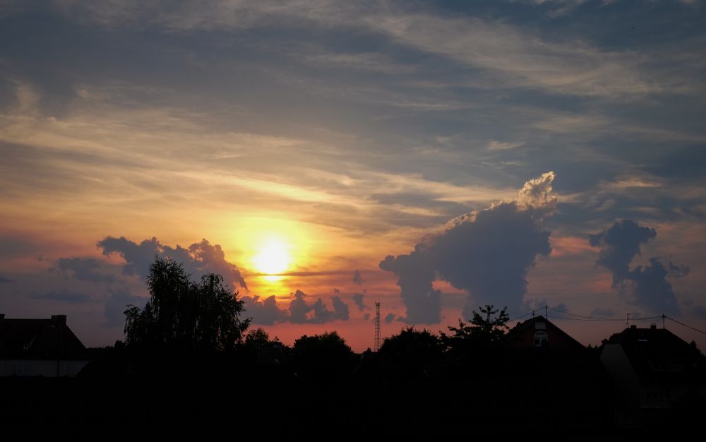 Clouds in a sunset sky over a French village