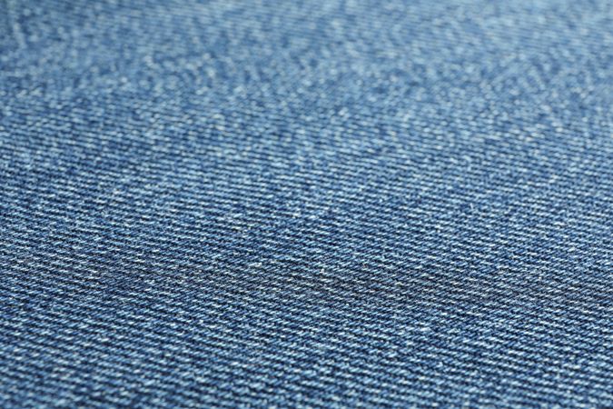 Texture of blue jeans as background, space for text