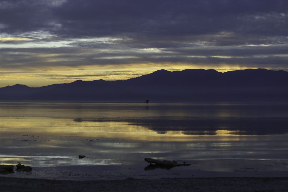Calm lake near silhouette of mountain