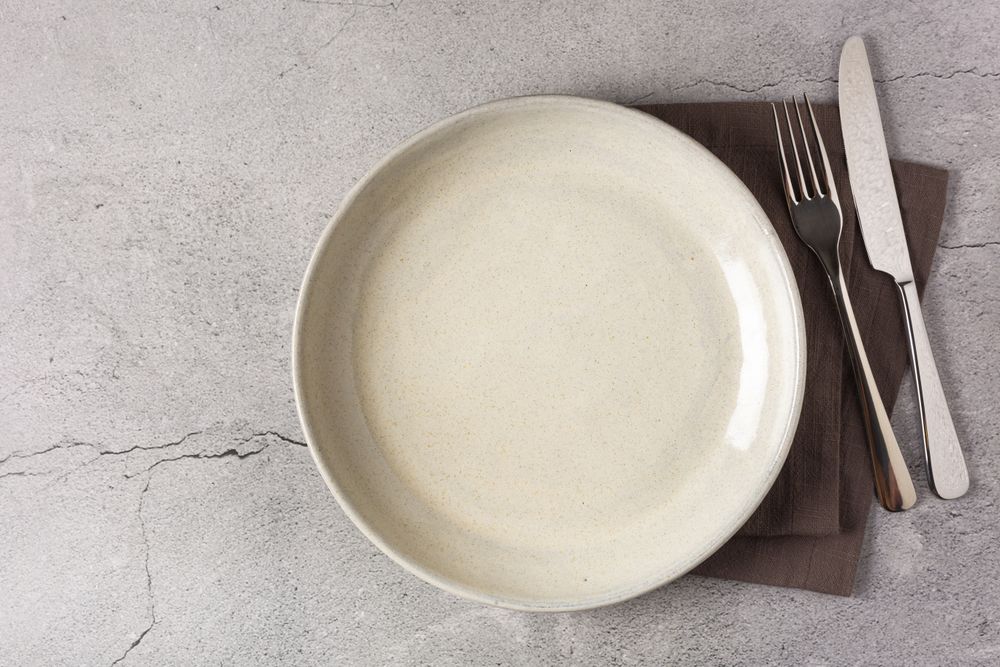 Empty plate on the slate table. Top view of the image.