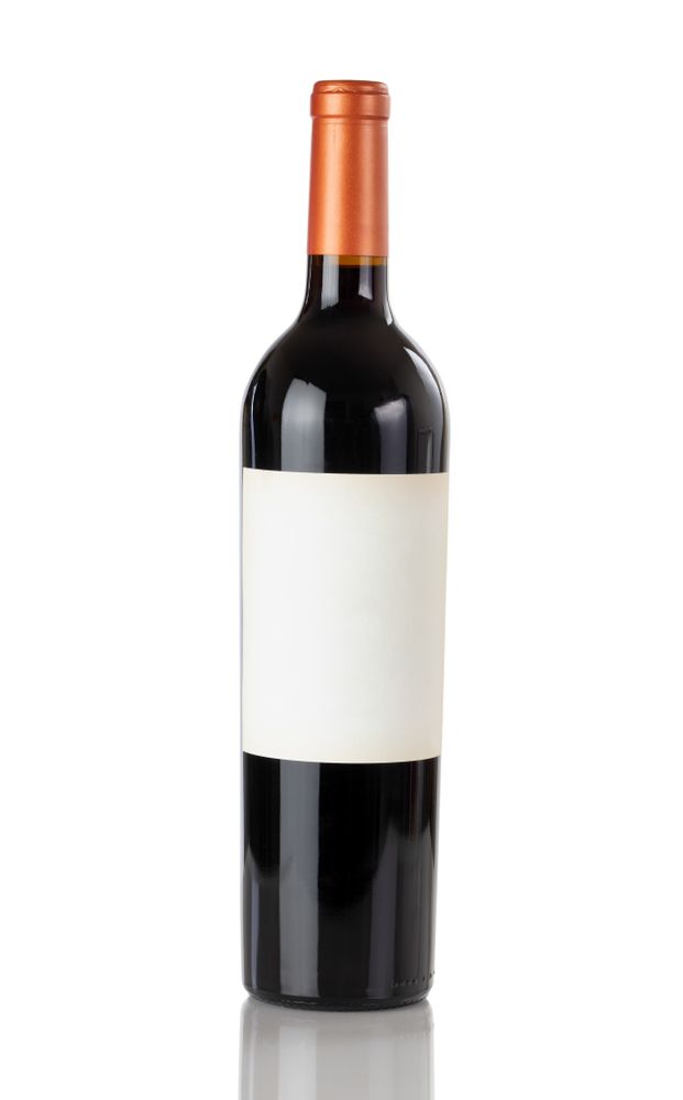 Unopen bottle of red wine isolated on a plain background with reflection
