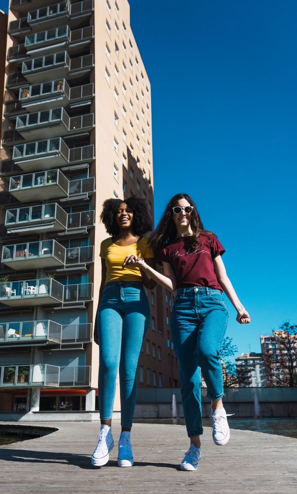 Two females skipping in town