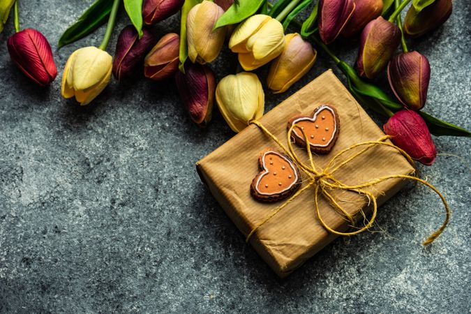 Valentine's day concept with gift, spring flowers and heart ornaments