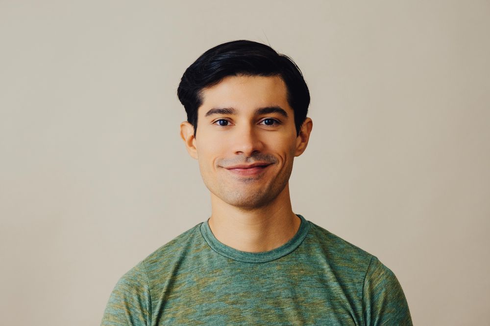 Portrait of Hispanic male in neutral room
