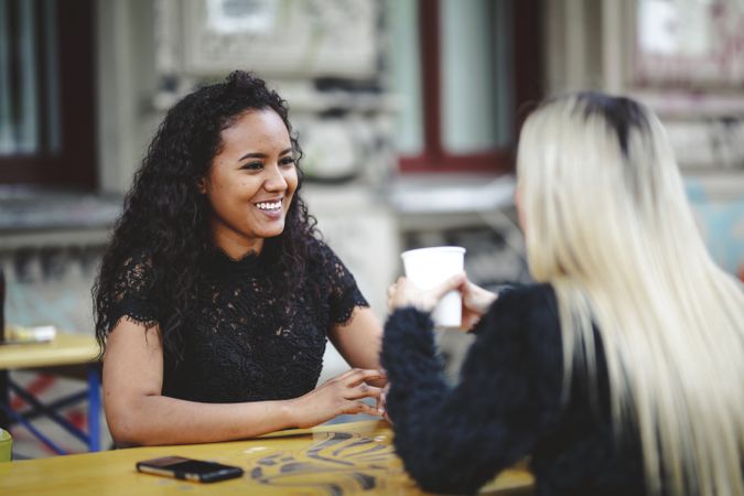 Friends talking in street cafe