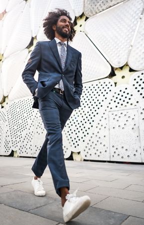 Male office worker walking near modern building
