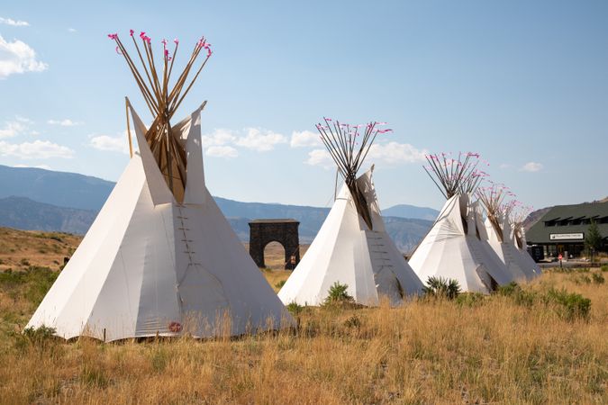 Montana, United States - August 17, 2022: Line of teepees in the mountains on summer day