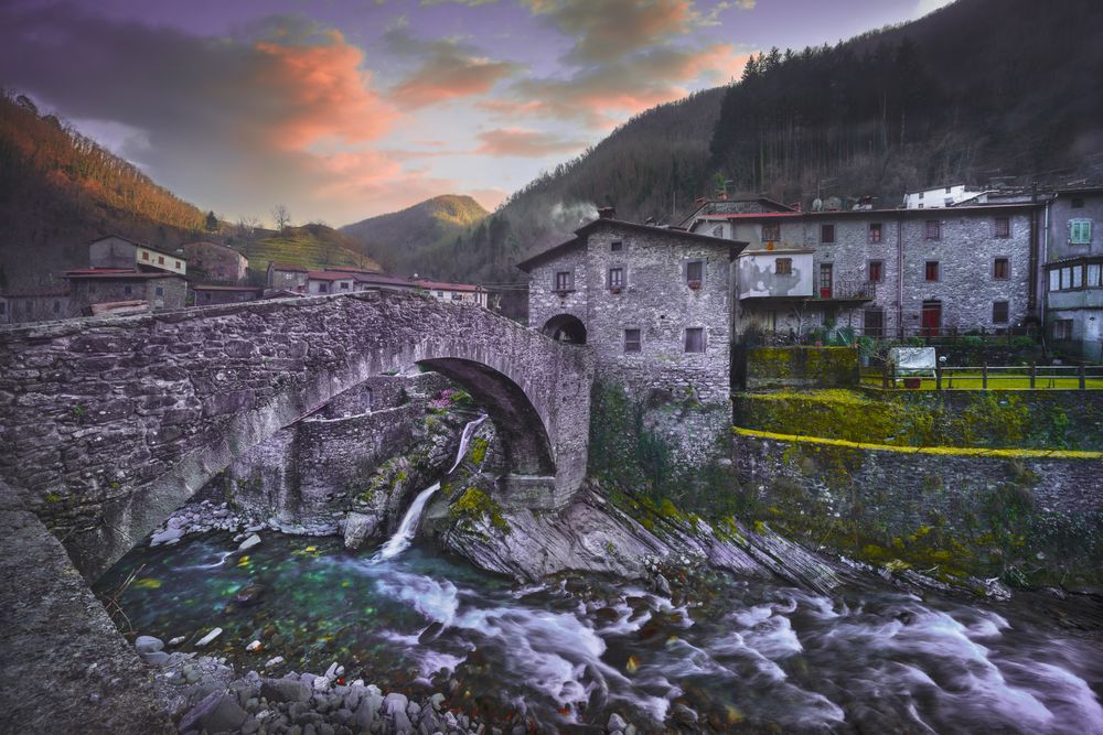 Fabbriche di Vallico ancient village and old bridge over the creek. Apuane park. Garfagnana, Tuscany, Italy.