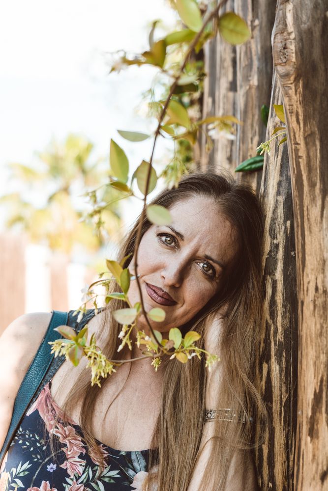 Adult woman behind tree twig