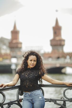 hispanic woman leaning on railing