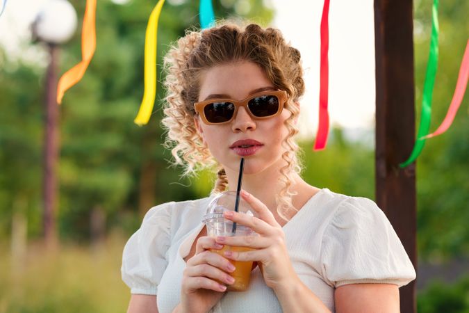 Woman with drink outdoors
