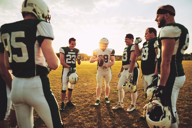 A football team strategizing on the field