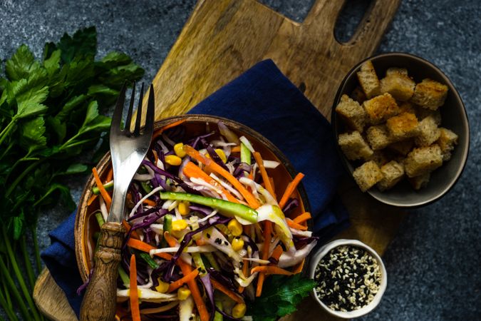 Healthy bowl of fresh salad with vegetables on stone background with copy space