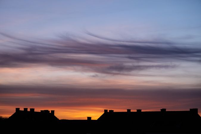 Colorful sky over French village at dawn