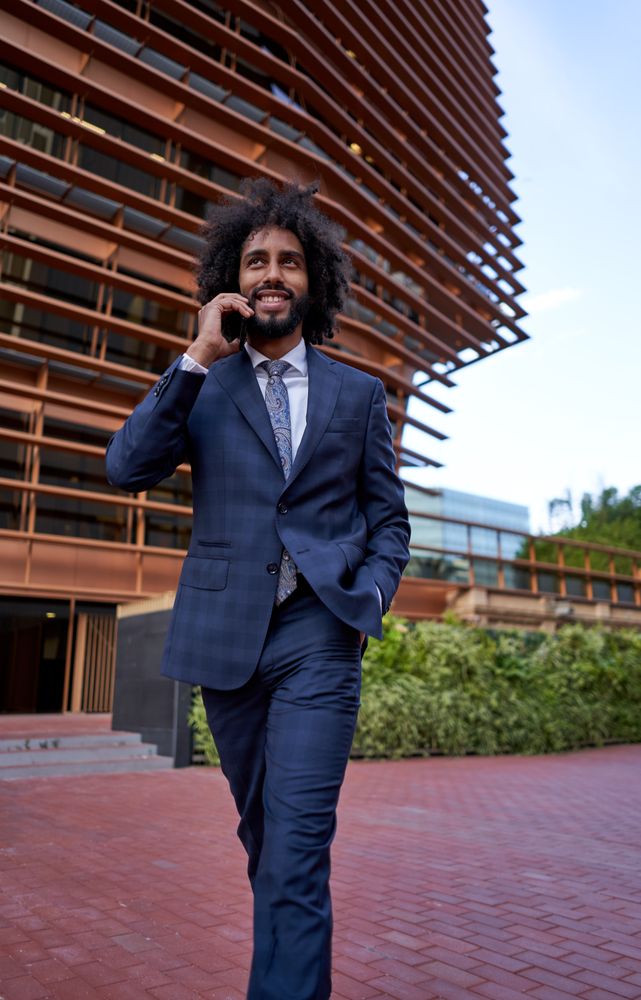 smiling businessman talking on smartphone