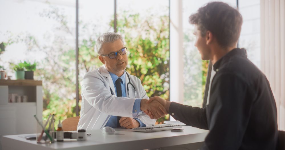 Mature Doctor is Having a Conversation with a Male Patient