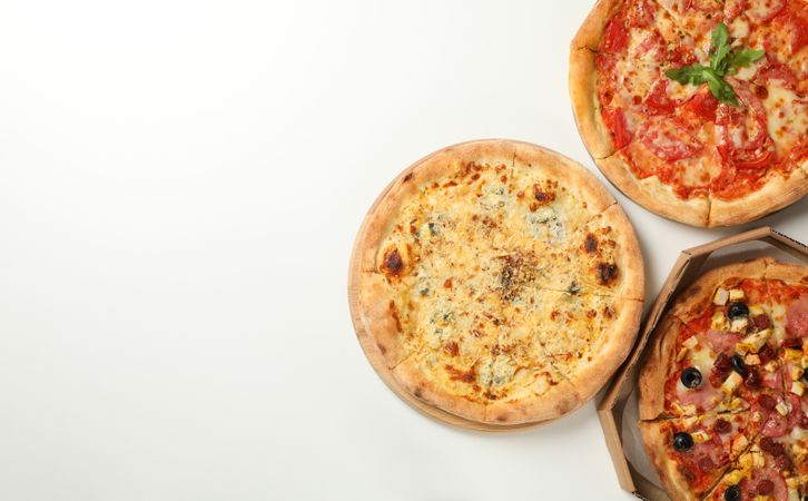 Three tasty pizza on plain background, space for text