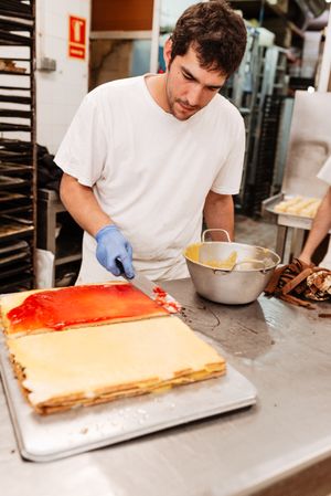 Baker with freshly glazed cakes