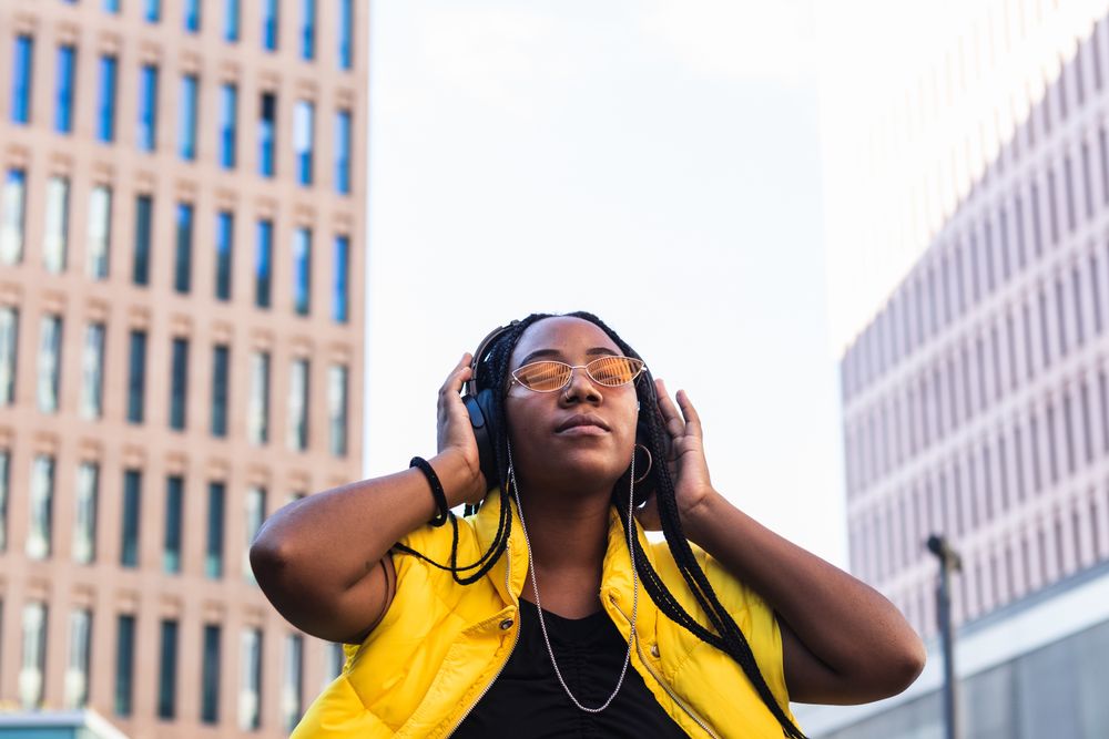 Glad female listening to music in city