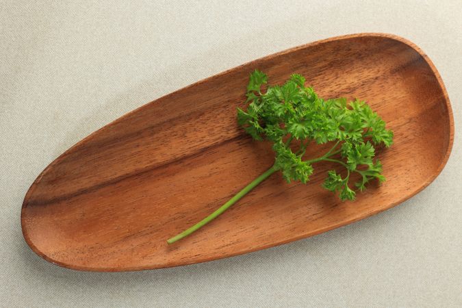 Fresh parsley on wooden plate