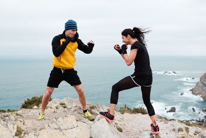 Kickboxers training on cliff