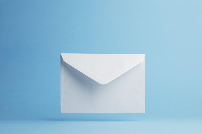 Floating blank envelope over light blue background