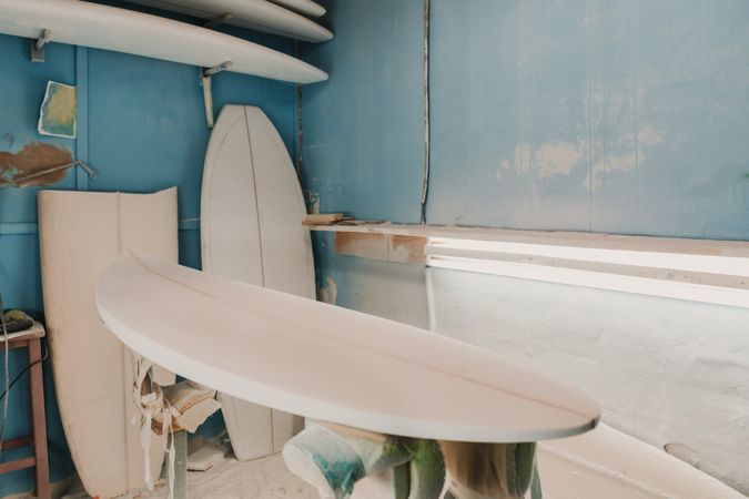 Workshop with surf boards near different tools