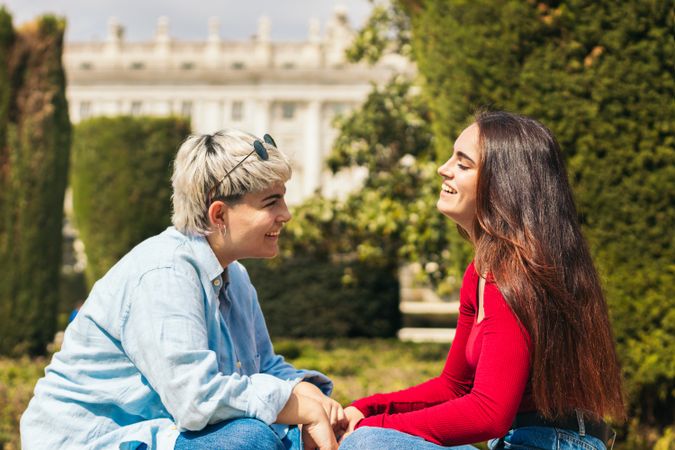 two young women sitting talking