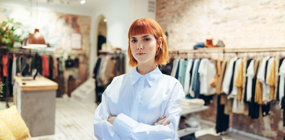 Fashionable woman in her retail clothing store looking at camera