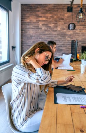 Business woman massaging her neck