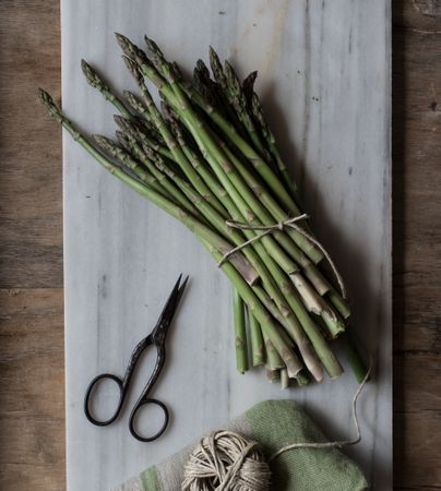 Arrangement of twine and asparagus on board