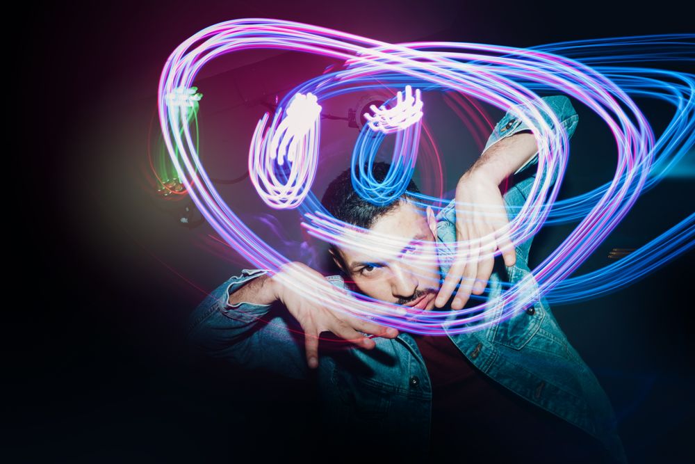bearded man dancing in spotlight