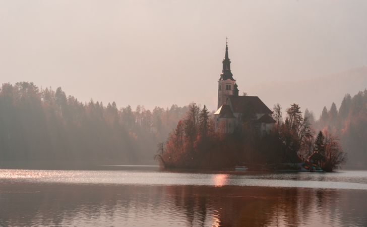 Lake Bled church landscape on a foggy morning day in winter