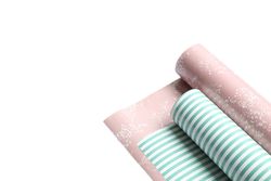 Rolls of festive wrapping paper on blank background. Space for text