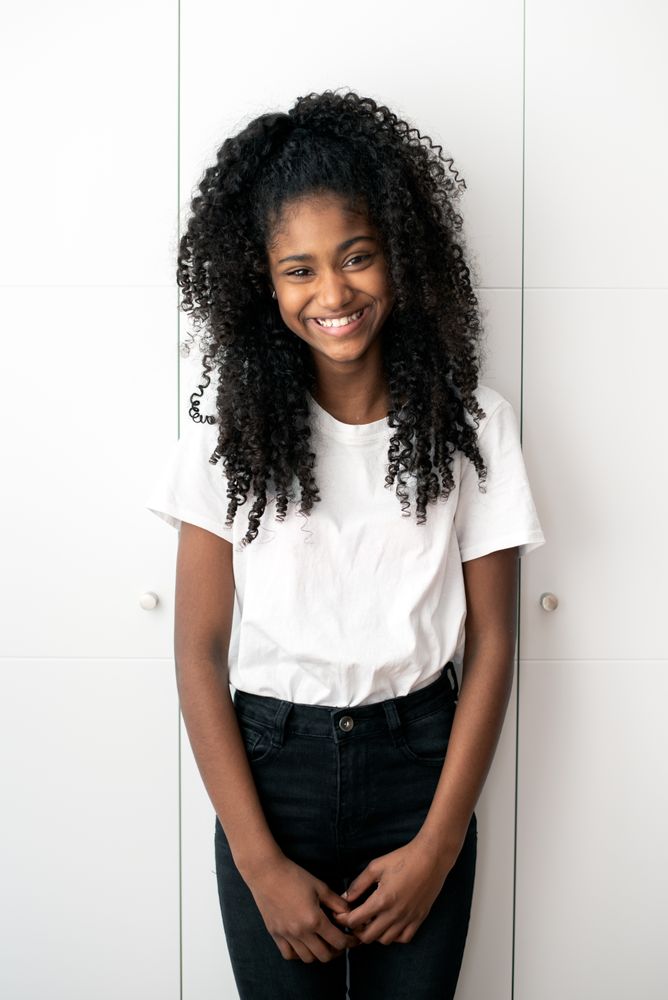 Portrait of a beautiful young Black teenage girl looking into camera